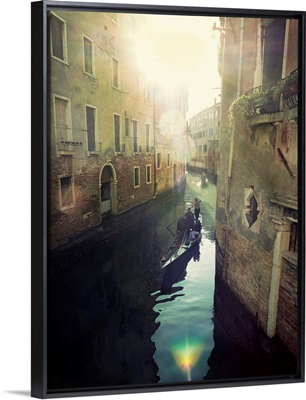 Two gondolas floating in water surrounded by old buildings.