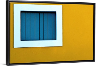 Window on yellow wall.