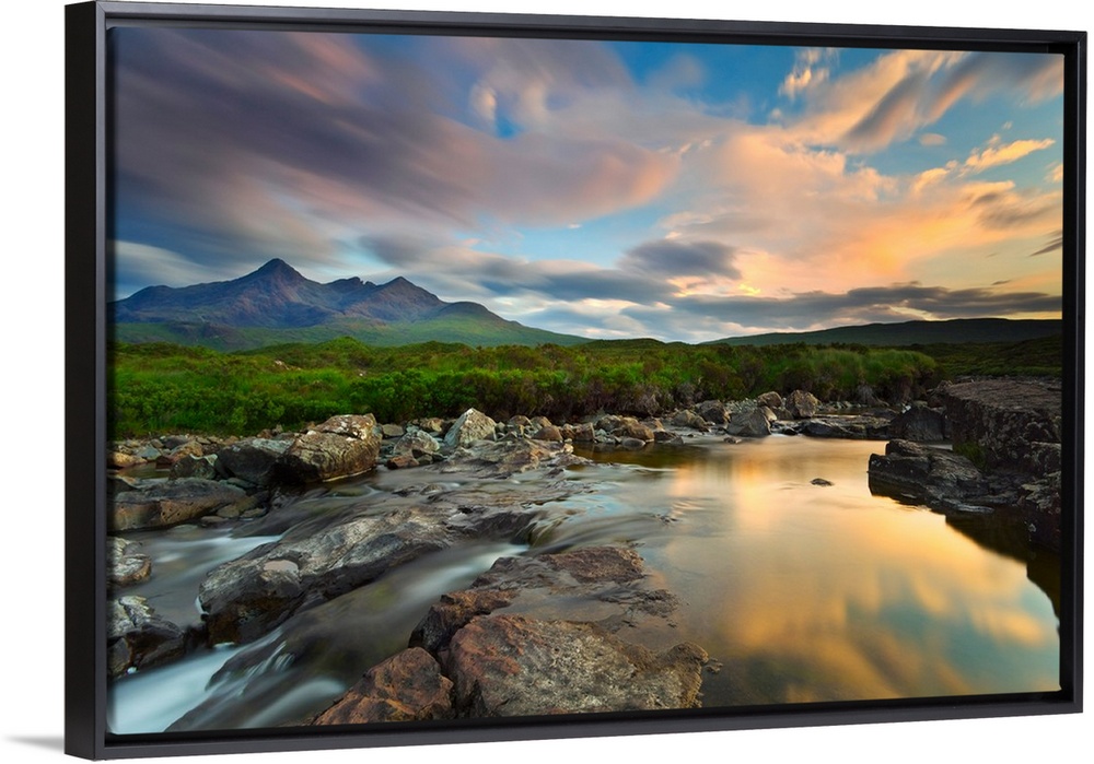 Isle of Skye, Scotland, Europe. The last sunset colors reflected in the water. In the background the peaks of the Black Cu...