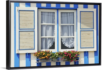 Window of a traditional striped house in the seaside village of Costa Nova, Portugal