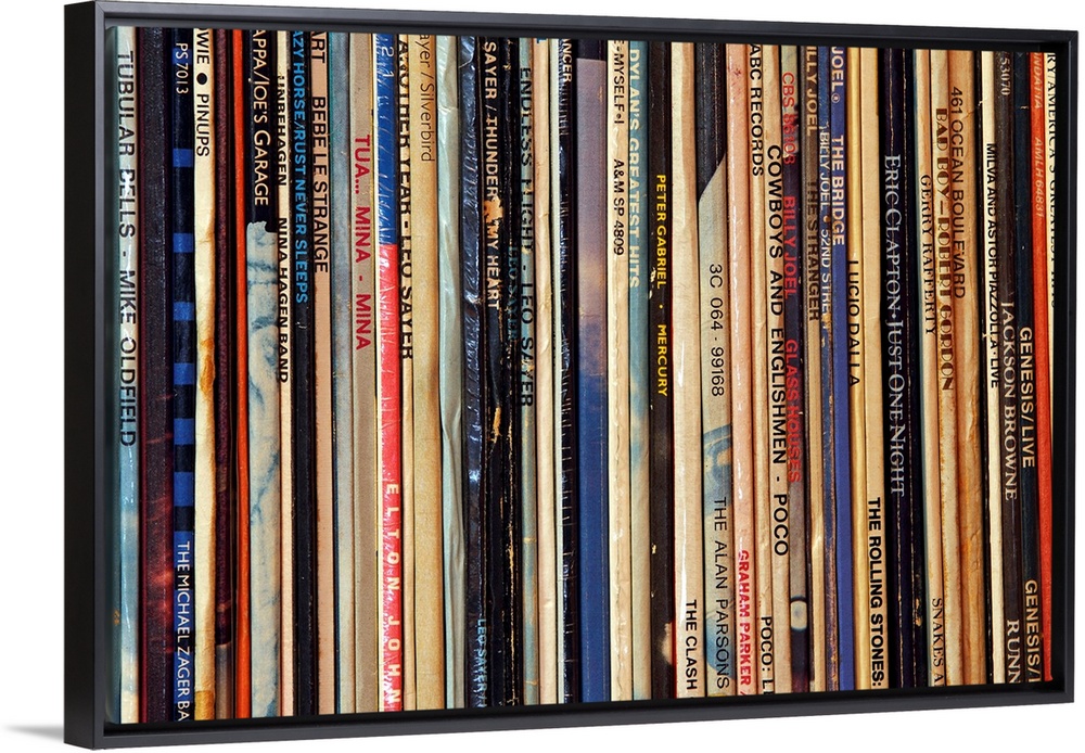 Big photograph shows a large collection of LP vinyl records that includes works from artists such as Eric Clapton, Billy J...