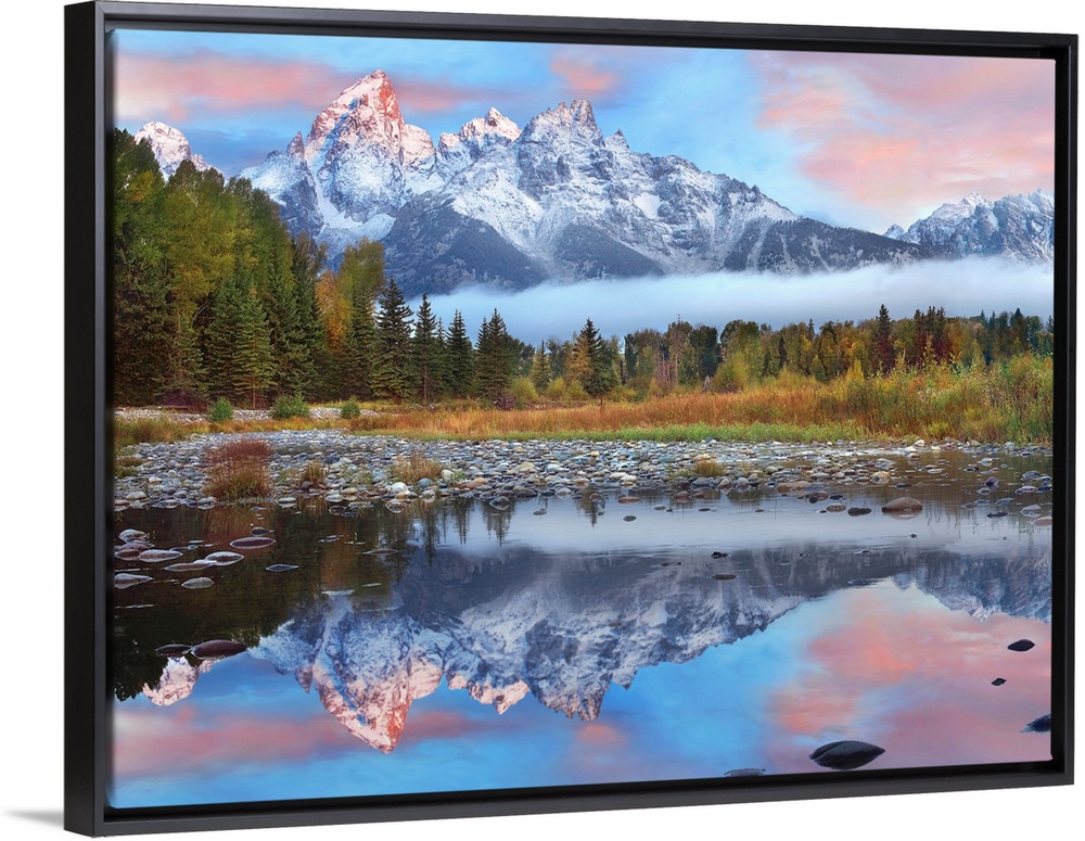 Giant photograph incorporates a large mountain range covered in snow reflecting over a calm body of water surrounded by a ...