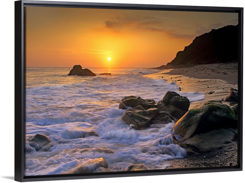 Large landscape photograph of a golden sunset over the rocky shoreline at Leo Carrillo State Beach, Malibu, California.