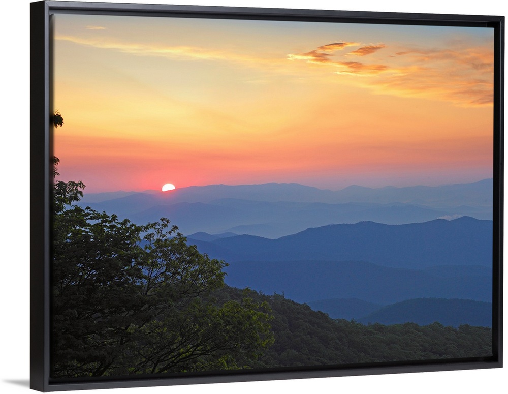Photo of the sun setting over the mountains from the Blue Ridge Parkway in North Carolina.