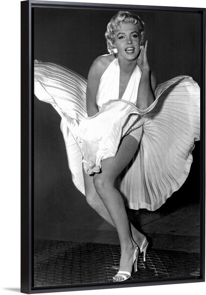 A vertical photograph of the actress in her white dress and high heels standing over a subway grate causing her skirt to b...