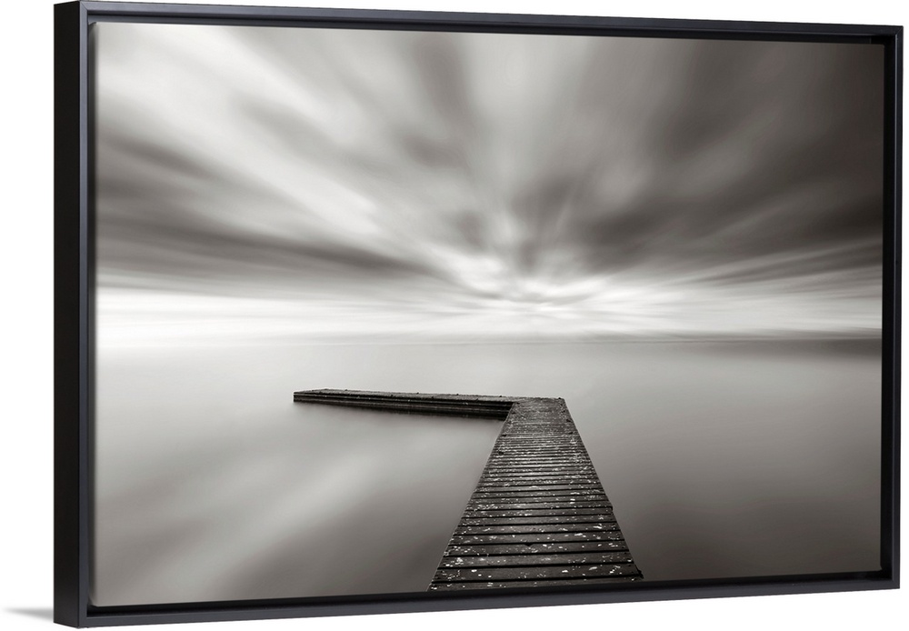 This wall art is a time lapsed photograph of this lake pier has created a sensation of motion in the sky and water which h...