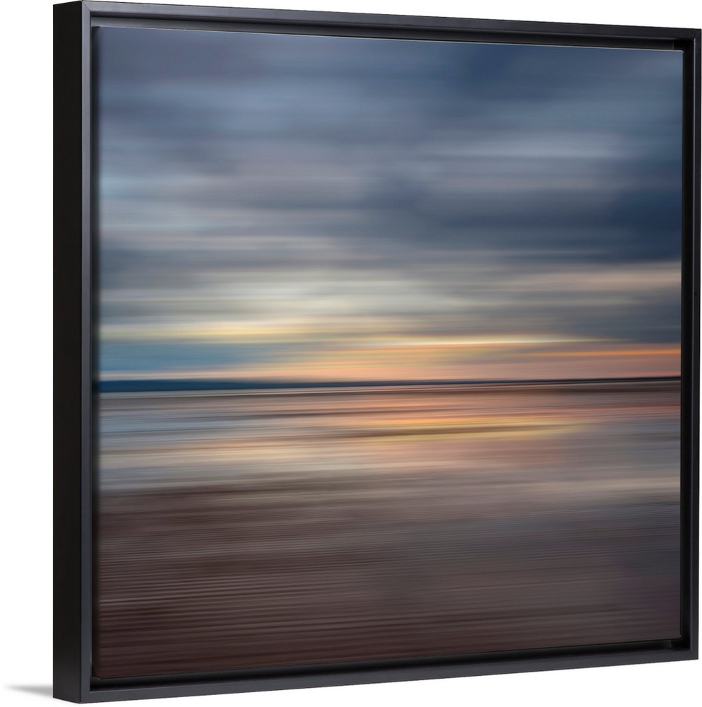 Oversized fine art photograph of sunset on a horizon in horizontal streaks of warm and cool tones.