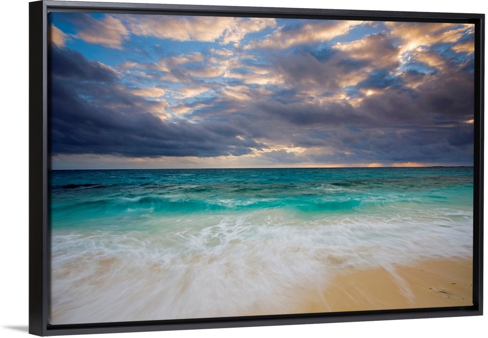 A giant photograph of a beach on the Ambergris Cay Island within the Turks and Caicos Islands.  The colorful ocean contras...