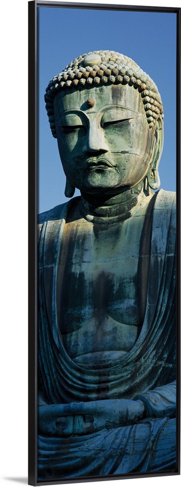 Only part of a Buddha statue is photographed for this tall panoramic piece.