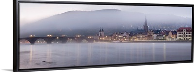 Bridge across a river with city lit up at morning, Germany