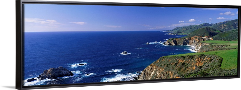 This wall art is a panoramic photograph of the coastal cliffs and the open ocean beyond.