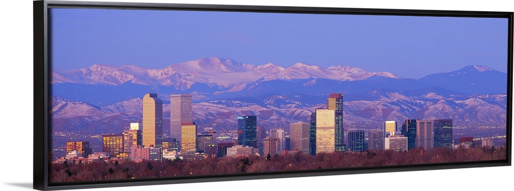 Panoramic view of the Rocky Mountains and downtown skyline of the Mile High City, Colorado in the early morning.