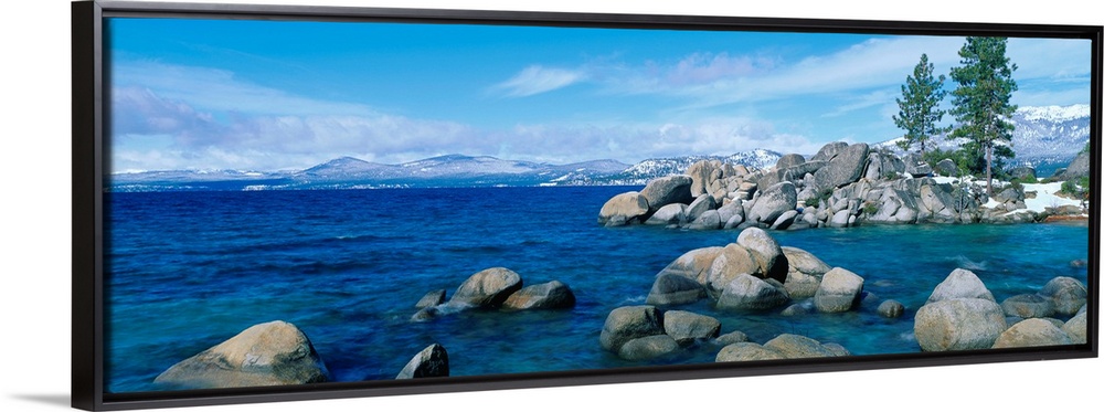 A panoramic photograph taken at eye level this home wall art shows the boulder covered shores of this world renowned lake.