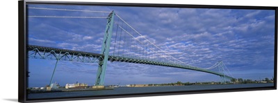 Low angle view of a suspension bridge over the river, Ambassador Bridge, Detroit River, Detroit, Michigan