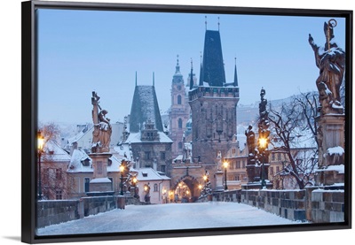 Prague, Charles Bridge tower and St. Nicolas church on winter morning