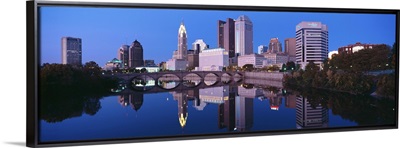 Scioto River and Columbus Ohio skyline, the capital city, at dusk with lights on