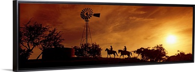 Silhouette of two horse riders at sunset, Hunt, Kerr County, Texas