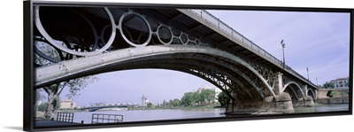 Spain, Seville, Low angle view of Isabel II Bridge over Guadalquivir River