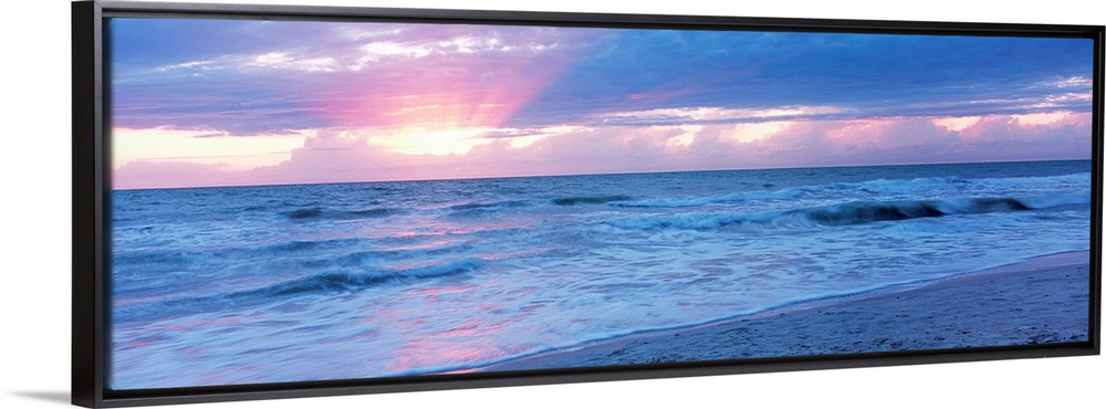 Large panoramic photo of the sun setting over a beach in Naples, Florida (FL).