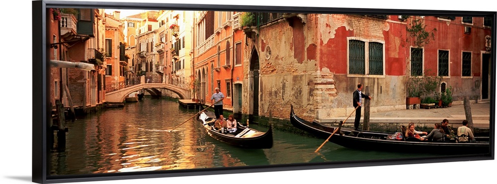 Gondolas paddling through canals lined with historic Venetian buildings.