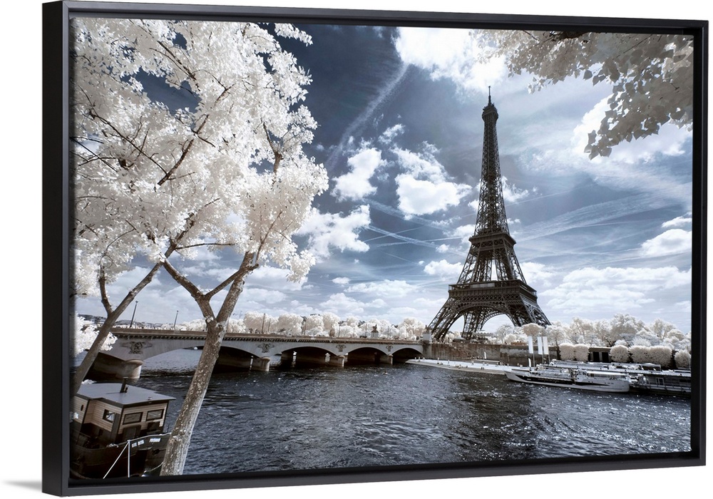 A view of the Eiffel Tower in Paris, made in infrared mode in summer. The vegetation is white and rendering of the sky is ...