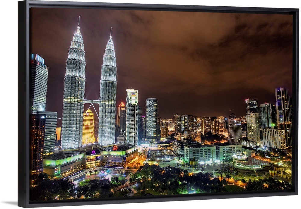 The Petronas Towers rising above the Kuala Lumpur city skyline at night, Malaysia.