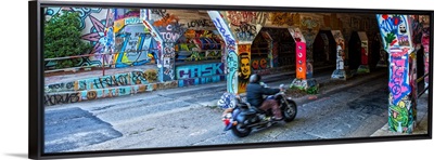 A motorcyclist enters the graffiti-covered Krog Street Tunnel in Atlanta, Georgia
