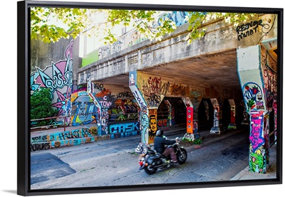 A motorcyclist enters the graffiti-covered Krog Street Tunnel in Atlanta, Georgia