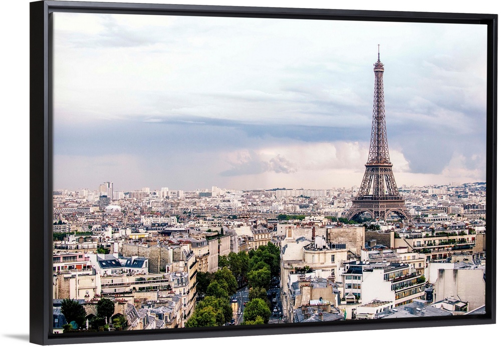 Aerial photograph of a Paris cityscape with the Eiffel Tower towering over all the buildings.