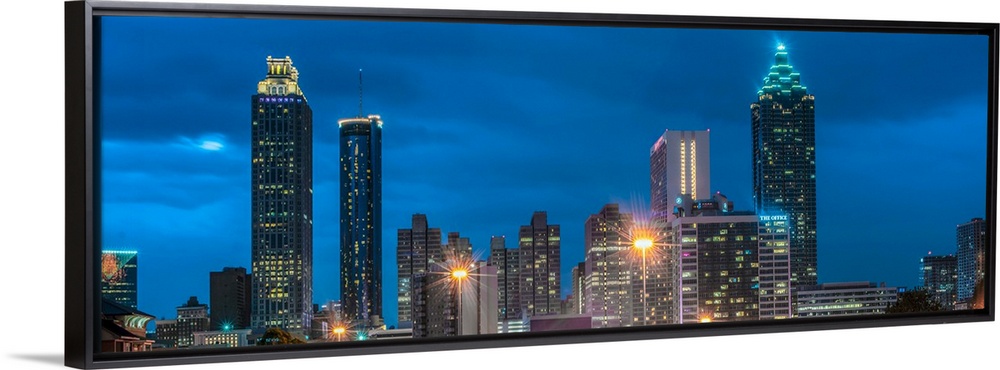 Skyscrapers in Atlanta, Georgia, illuminated at night against a deep blue sky.