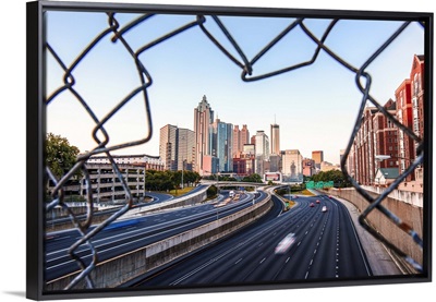 Atlanta, Georgia skyline framed by a chain link fence