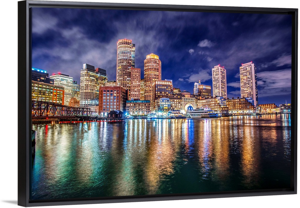 The lights of downtown Boston reflect upon Massachusetts Bay.