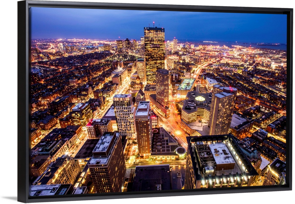 Aerial view of the city of Boston, Massachusetts, lit up at night.