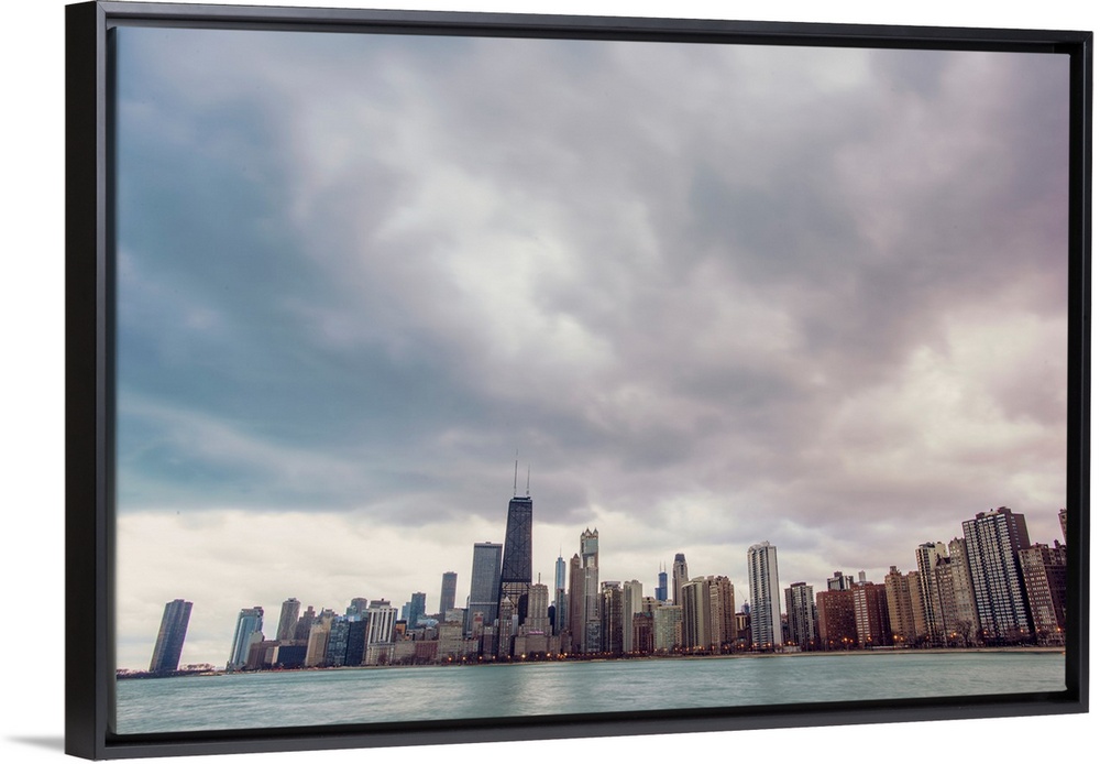 Photo of Chicago's skyline under dramatic clouds.