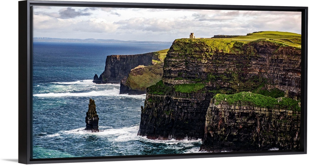 Panoramic photograph of the Cliffs of Moher with O'Brien's Tower seen in the distance, marking the highest point of the Cl...