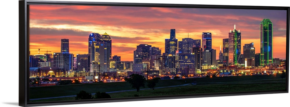 A horizontal image of the Dallas, Texas city skyline with a brilliant sunset.