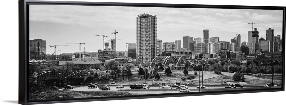 Photograph of the Denver, Colorado skyline with cloudy skies above.