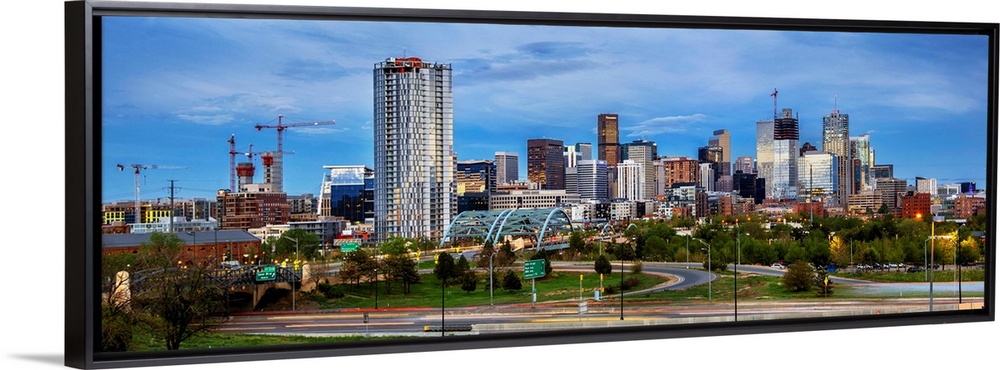Photo of a Denver's skyline with light trails.