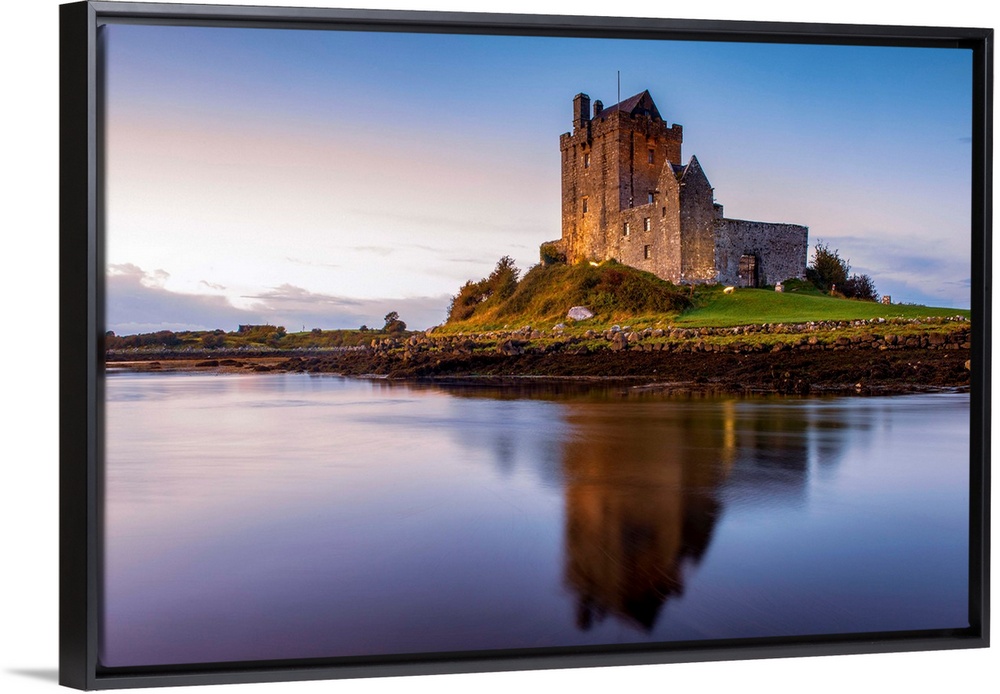 Landscape photograph of the Dunguaire Castle reflecting into the water on the southeastern shore of Galway Bay in County G...