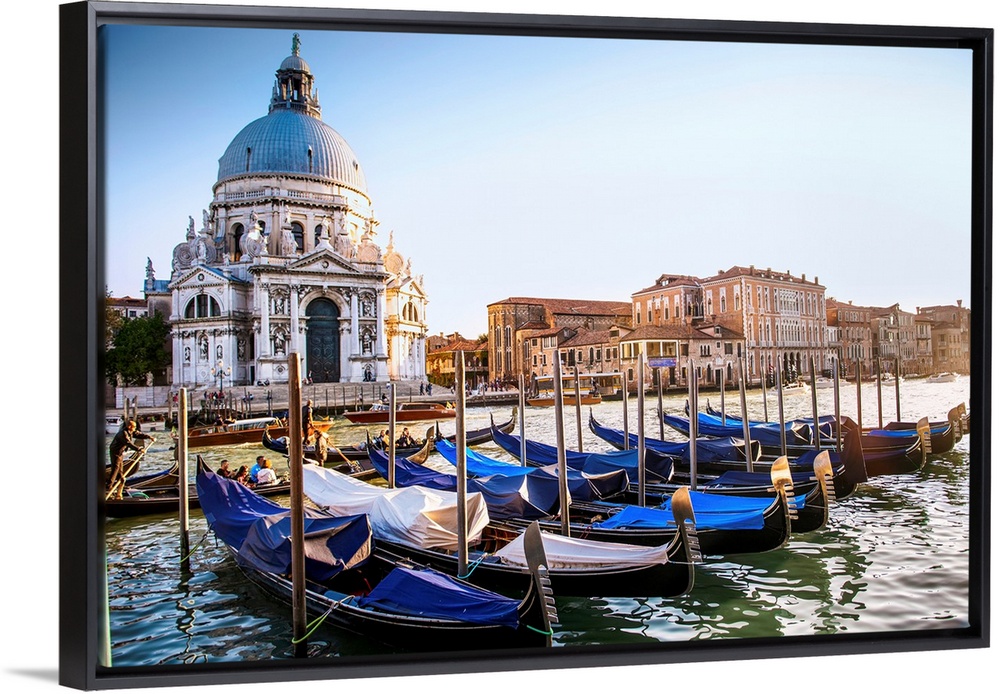 Photograph of gondolas lined up in a row in front of Santa Maria della Salute, Venice, Italy, Europe