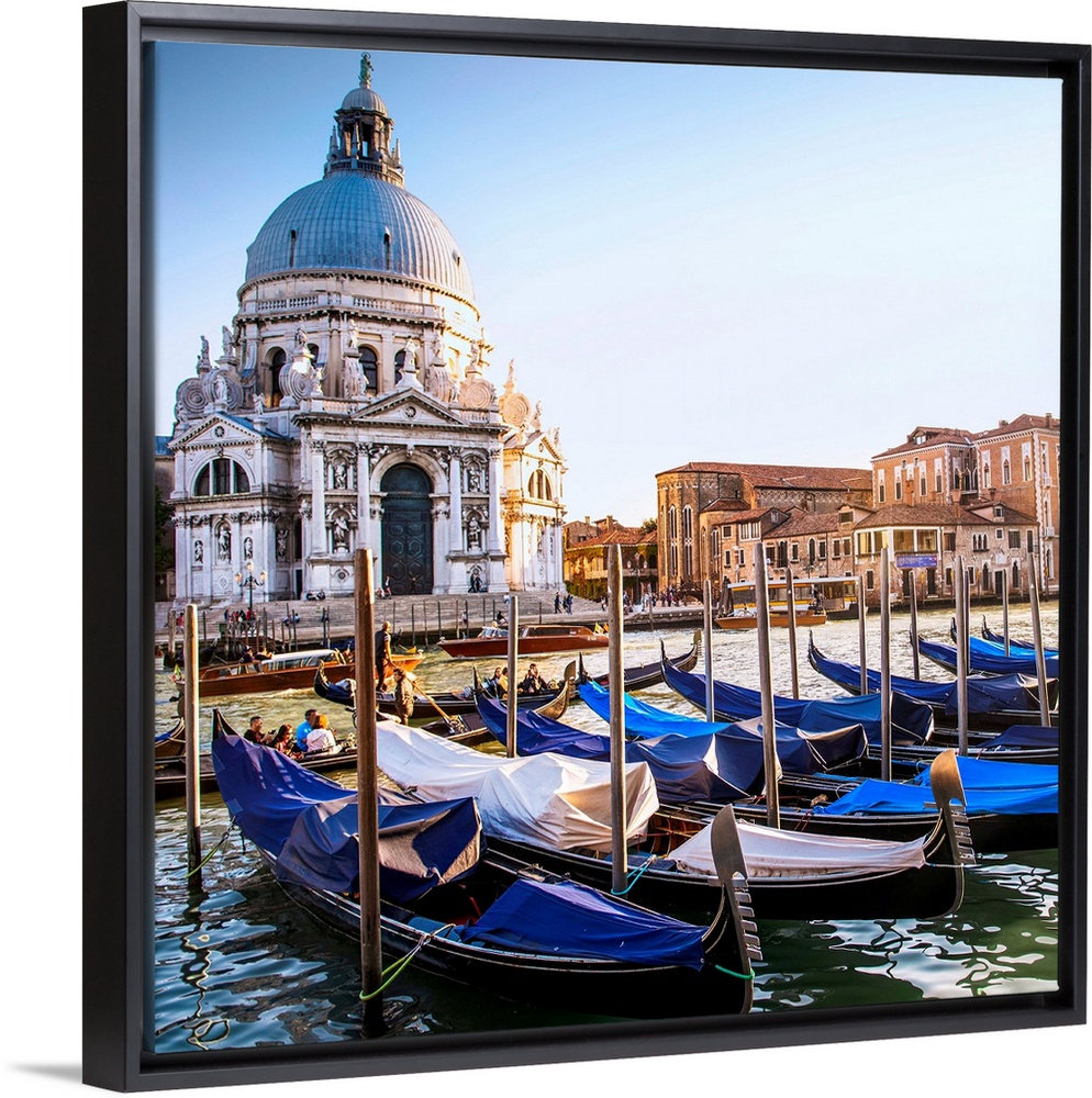 Square photograph of gondolas lined up in a row in front of Santa Maria della Salute, Venice, Italy, Europe