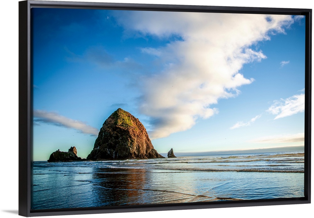 Panoramic photograph of Haystack Rock at golden hour, just before sunset, Cannon Beach, Oregon.