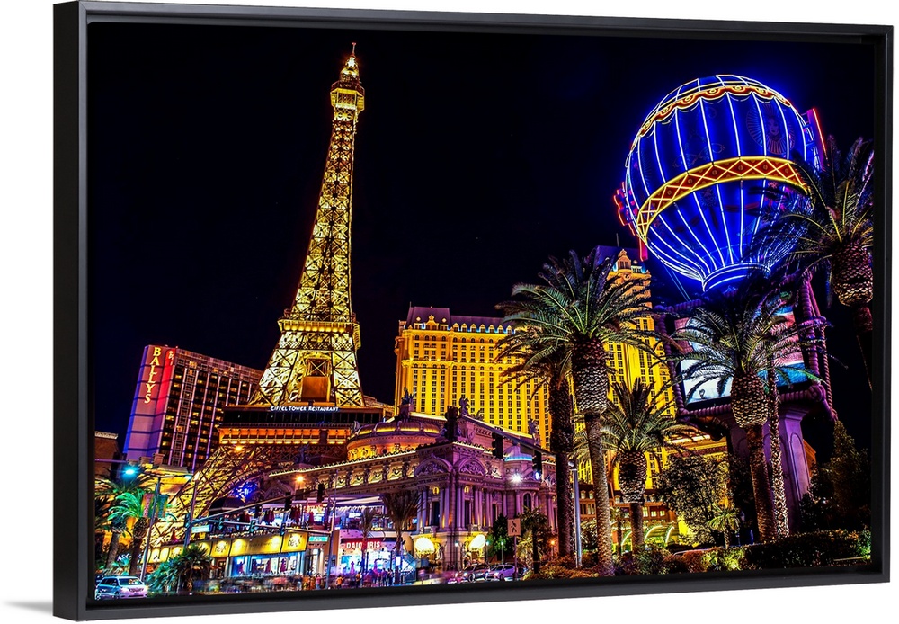 Evening photograph of the Las Vegas strip with the Eiffel Tower and hot air balloon.