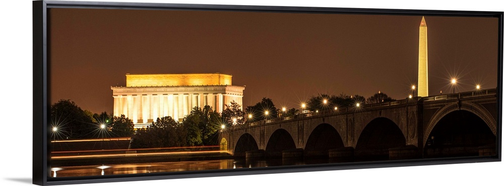 Panoramic photograph of the Lincoln Memorial and Washington Monument lit up at night in Washington, DC.