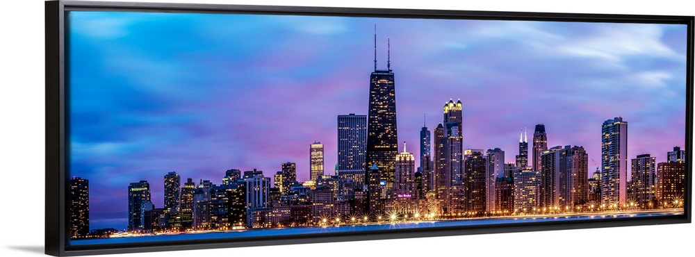 Photo of Chicago skyline at night under cotton candy colored clouds.