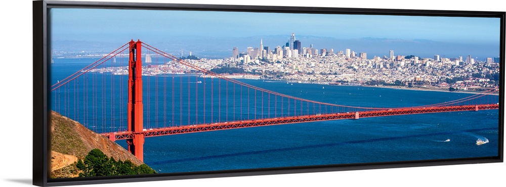 Panoramic photograph of the Golden Gate Bridge with San Francisco's skyscrapers in the background.