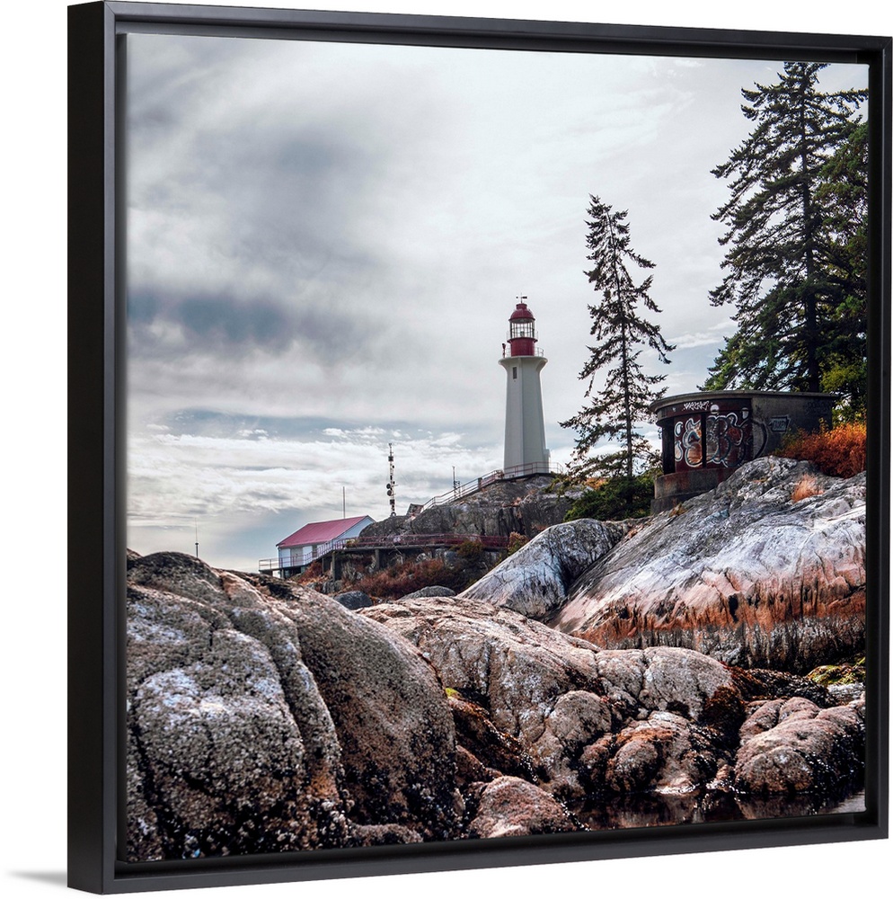 View of Point Atkinson Lighthouse and rocky shore in Vancouver, British Columbia, Canada.