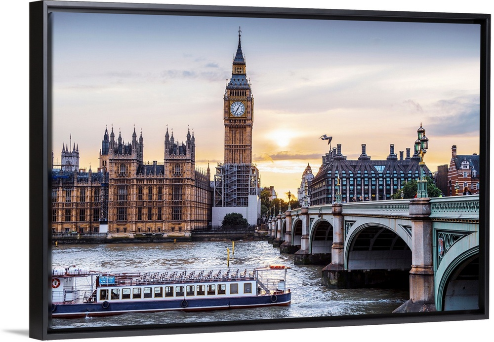 Photograph of a river boat on the River Thames about to go under the Westminster Bridge with Big Ben in the background.