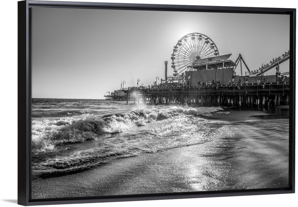 Photograph of the Santa Monica Pier in Los Angeles, California, with the sun setting right behind the Ferris Wheel.