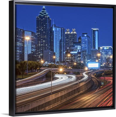 Skyline of Atlanta, Georgia, at night with light trails in the streets